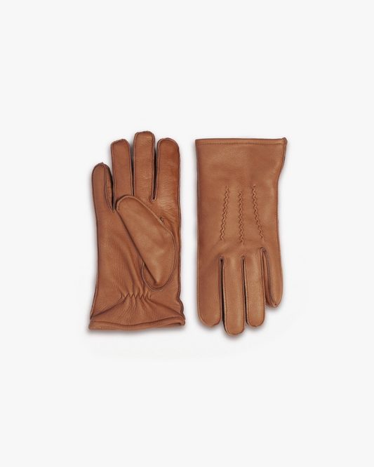 A pair of Gloves – Cognac Deer Leather on a white background, one showing the stitched back and the other the palm.