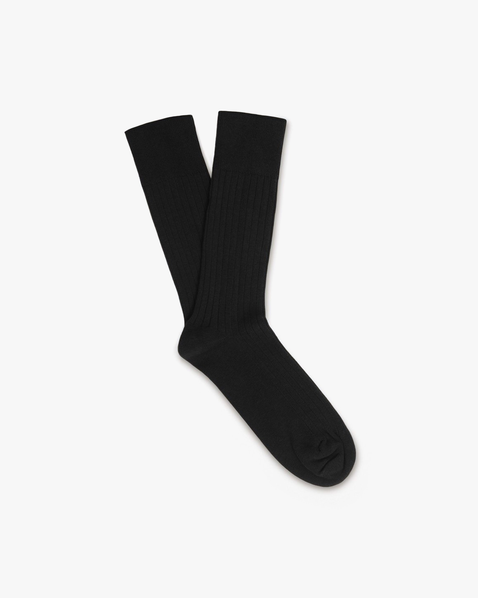A pair of black, ribbed Oscar – Cotton Socks laid flat against a white background.