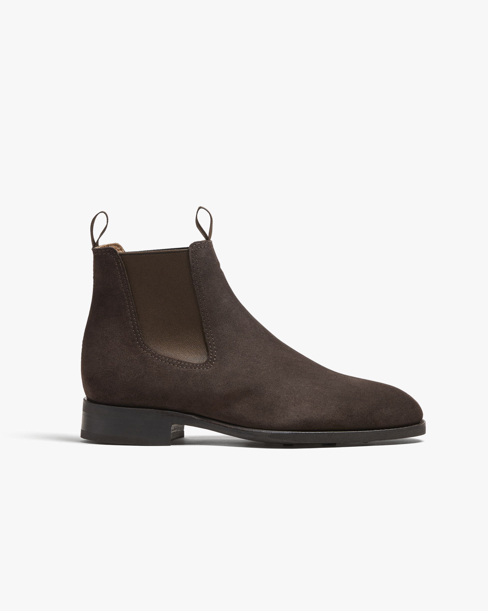 A studio shot of Granhult – Dark Brown Suede, a Chelsea boot, pictured from the side against a white background.