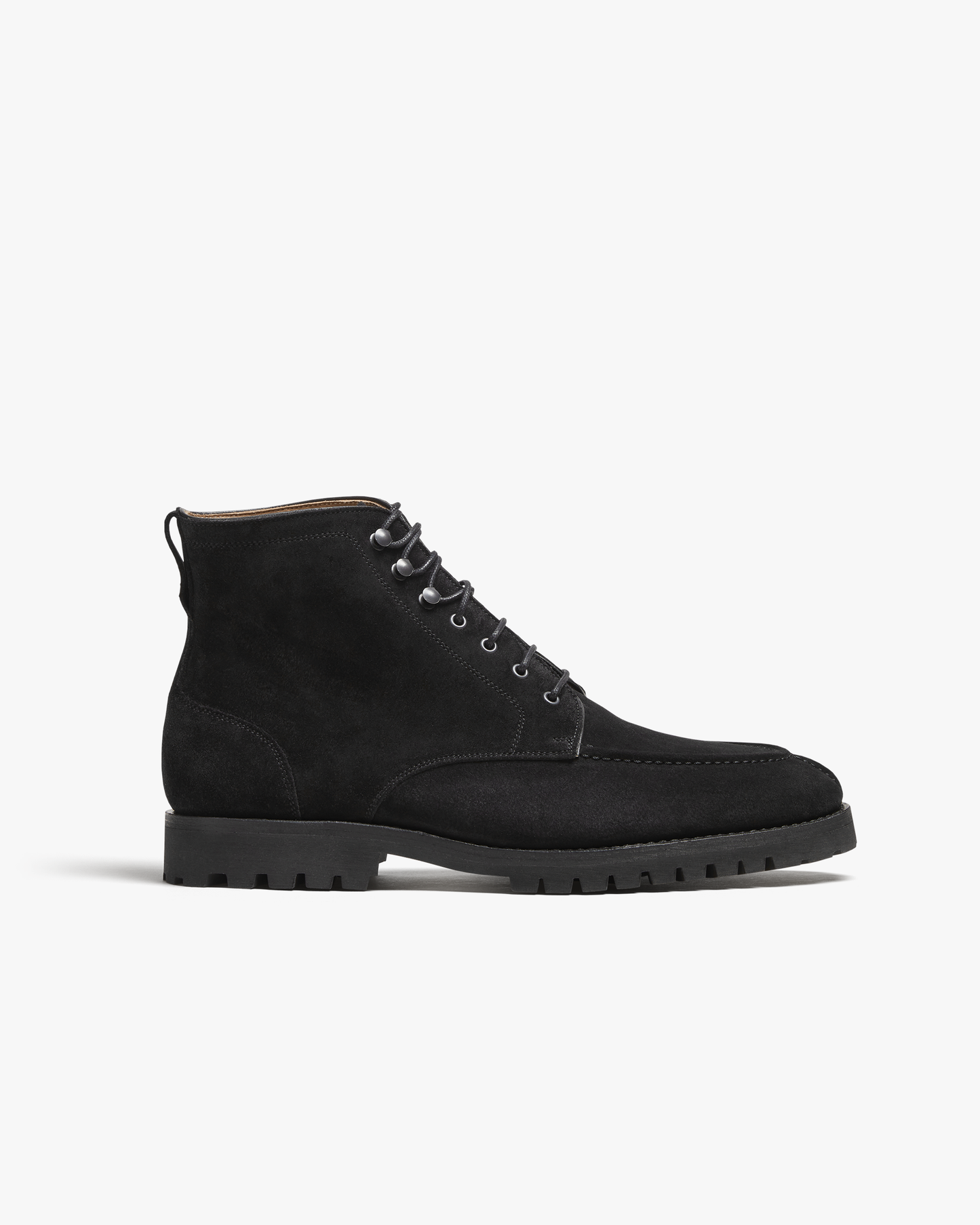 Side profile studio shot of Gothem – Black Suede, a black suede jumper boot with a rugged commando sole.
