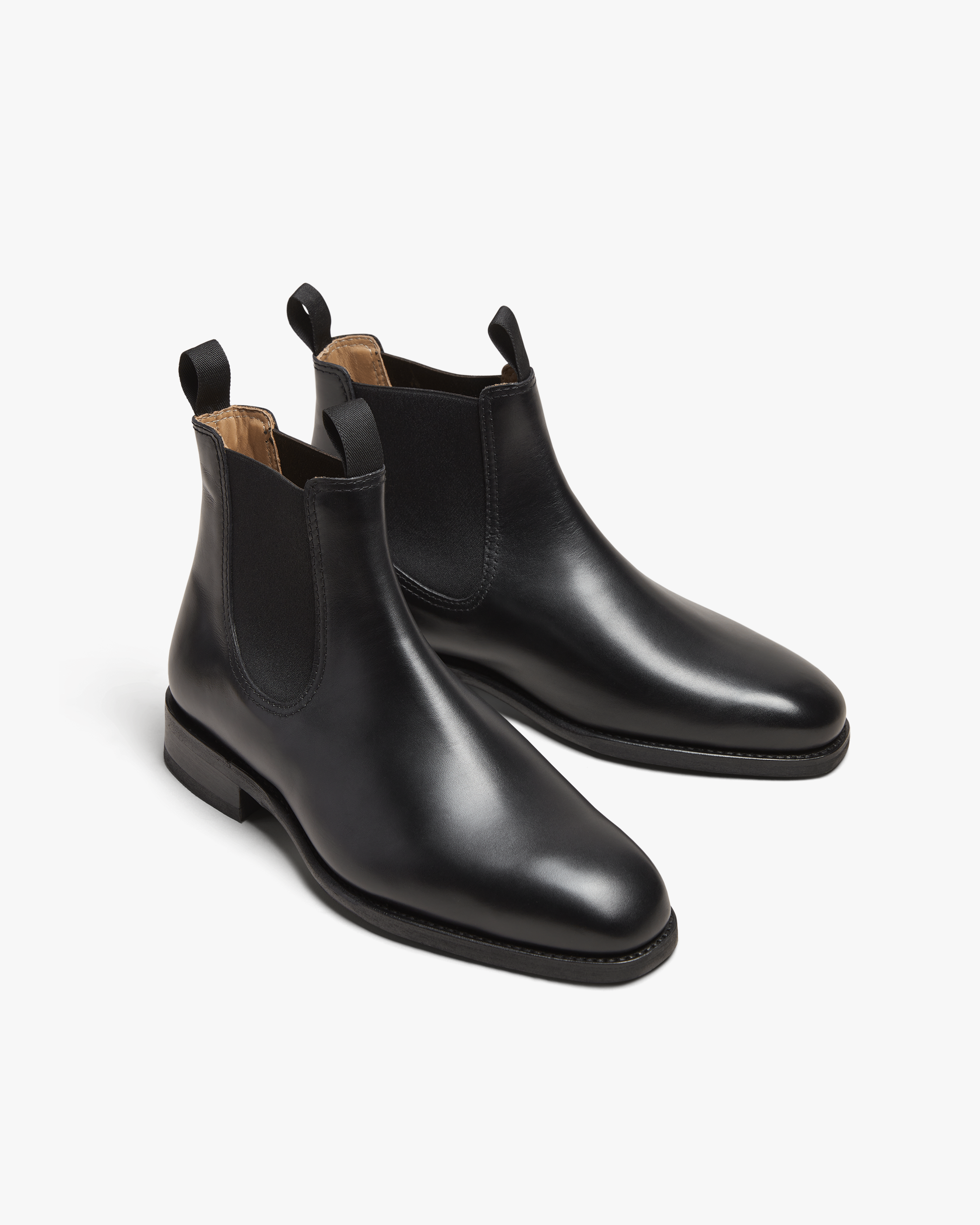 A three-quarter studio view of Granhult – Black Calf Chelsea boots, highlighting their smooth leather and soft chisel toe.