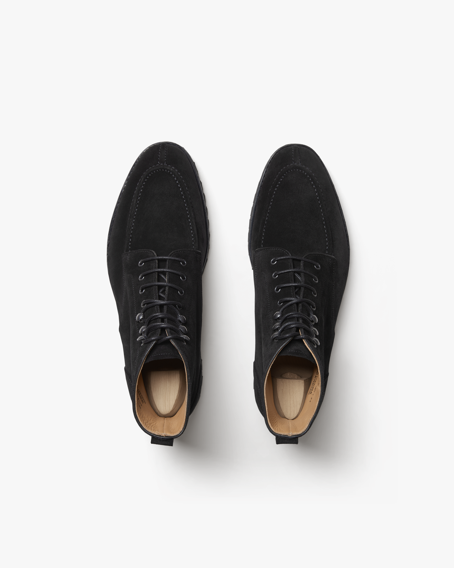 A studio photograph from above of the Gothem – Black Suede boots, highlighting their split-toe construction.