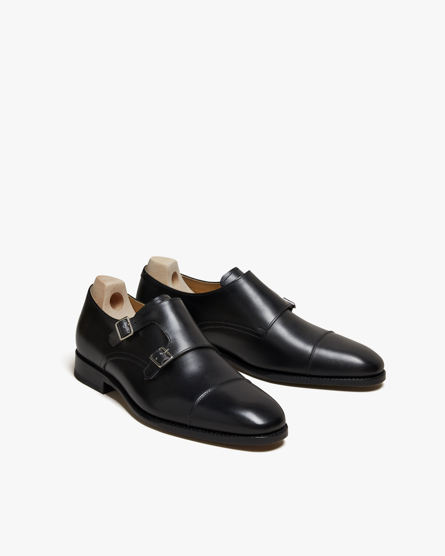 A pair of Ålsten – Black Calf double monk strap shoes shown at a three-quarter angle against a white studio background.