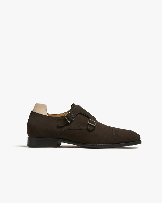 A profile view of the Ålsten – Dark Brown Suede, a cap toe double monk strap shoe, set against a white background.