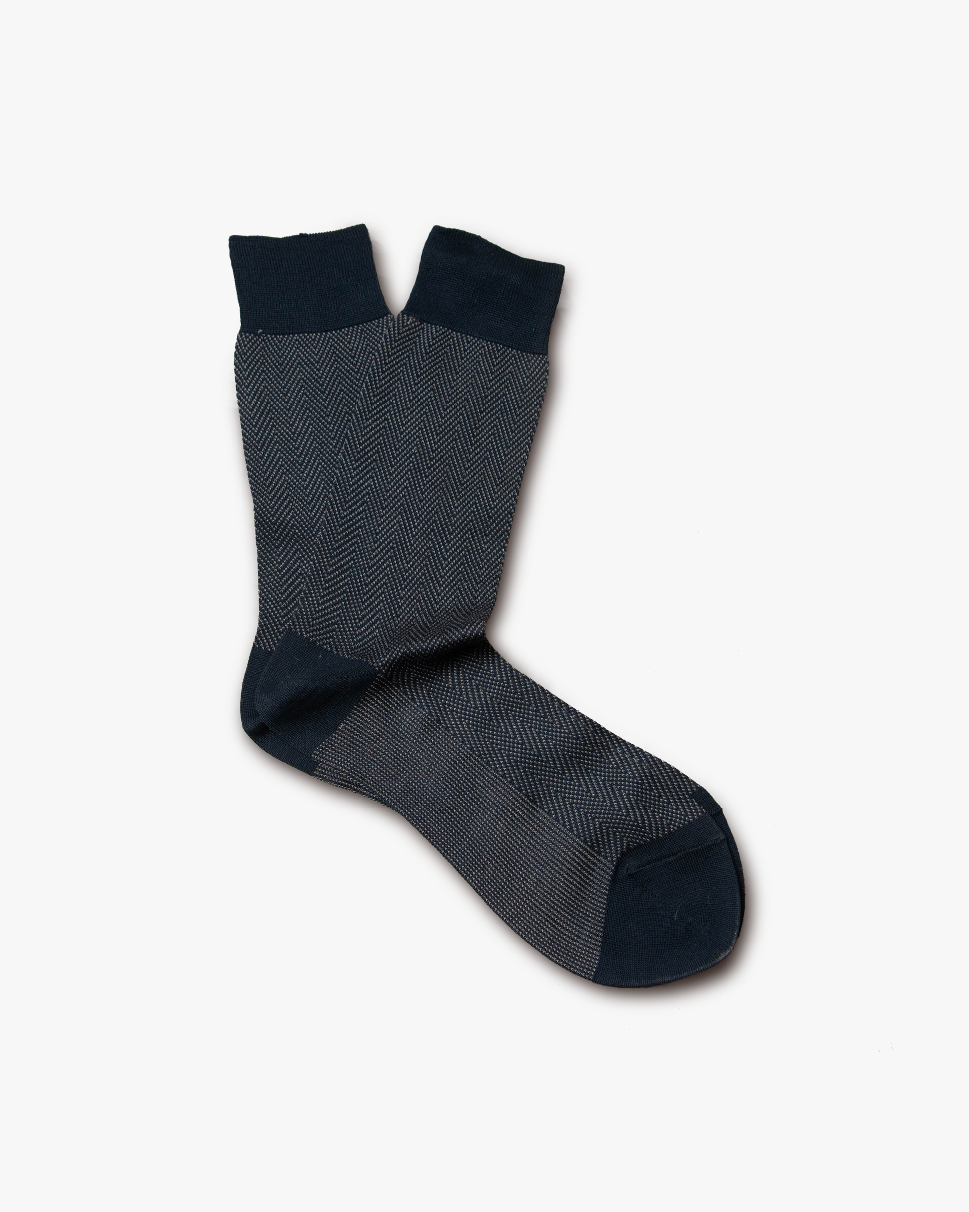 A pair of Arvid – Cotton Socks – Blue with a herringbone pattern, displayed on a white background.