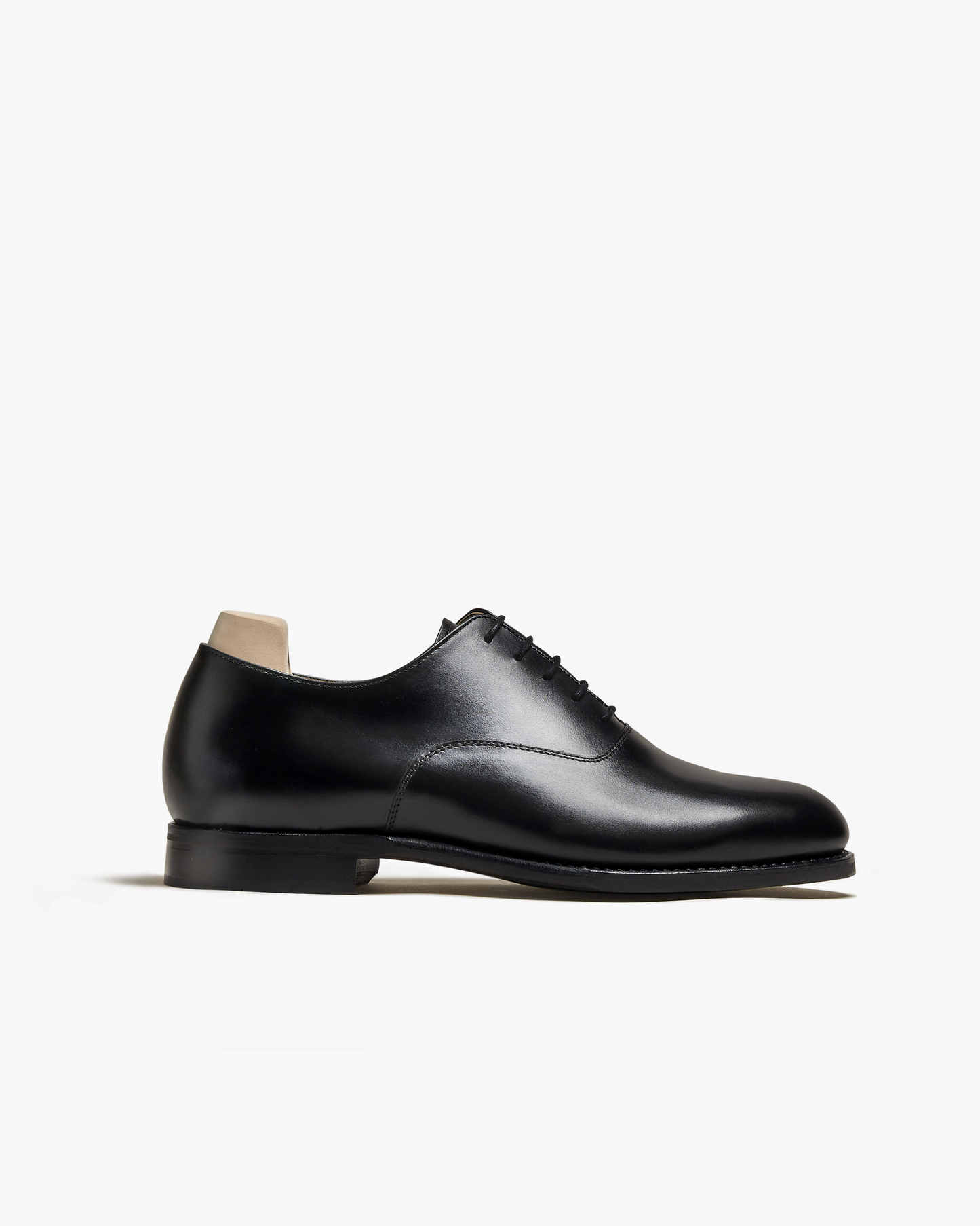 A side profile of Arvika II – Black Calf, a plain toe oxford shoe in black calf leather, shot against a white background.