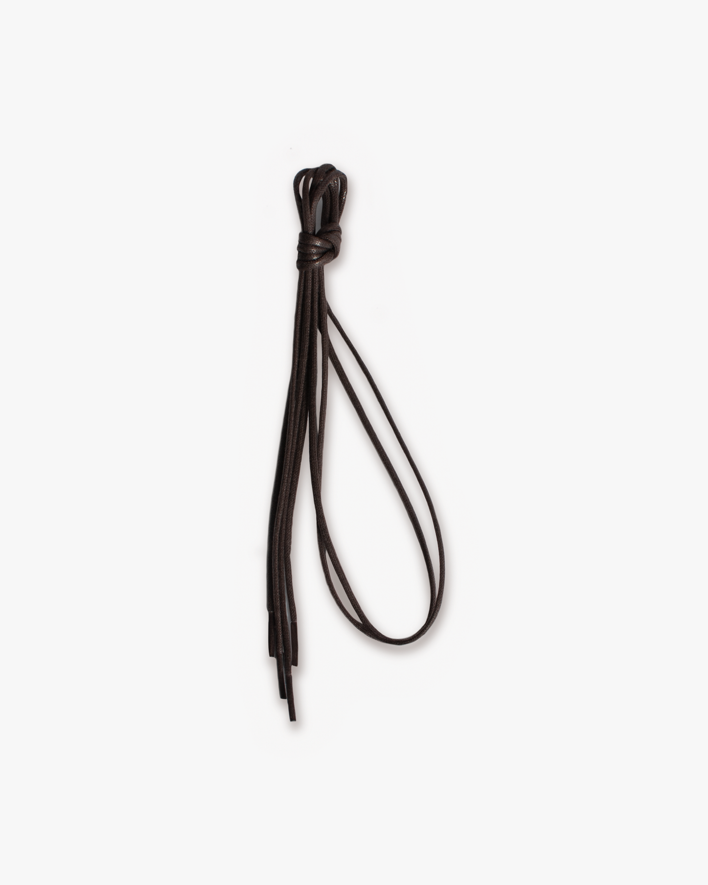 A close-up of brown waxed shoelaces, neatly tied in a bundle against a clean white background.