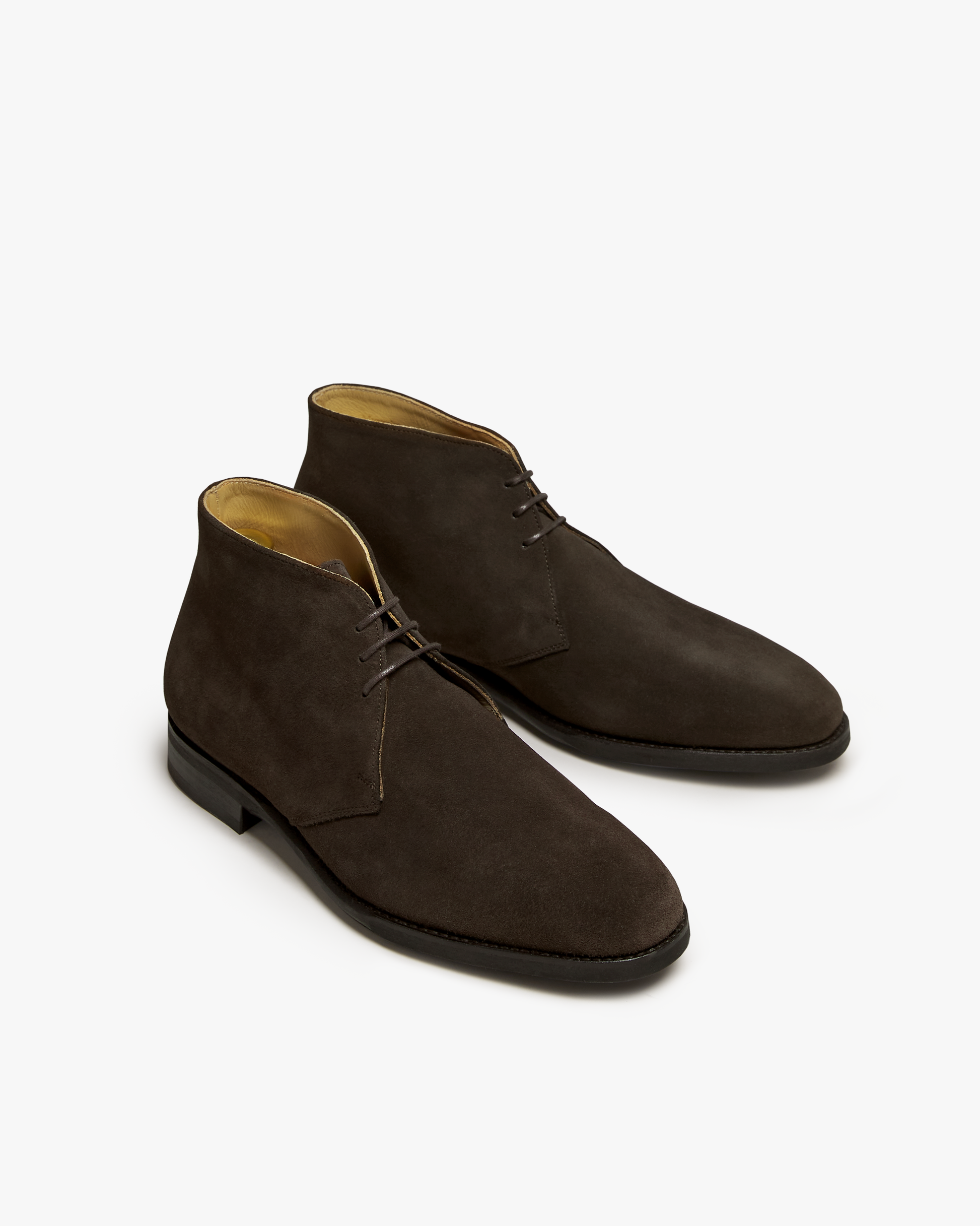 A pair of Gyllsjö – Dark Brown Suede chukka boots, showcasing their softly chiseled toe and refined silhouette.