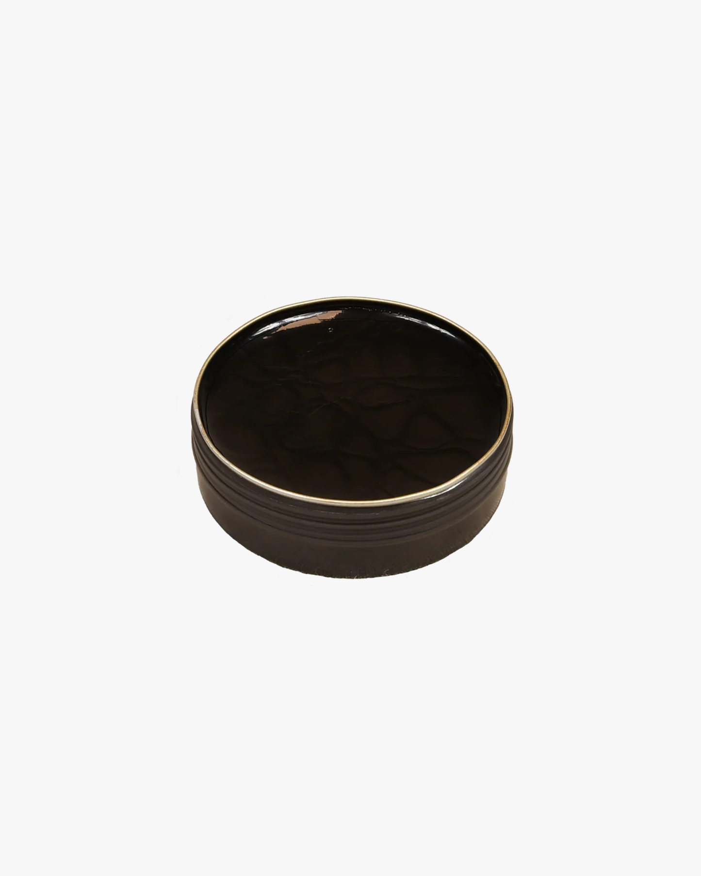 A detailed shot of the open tin of Saphir – Pâte de Luxe shoe wax in black.