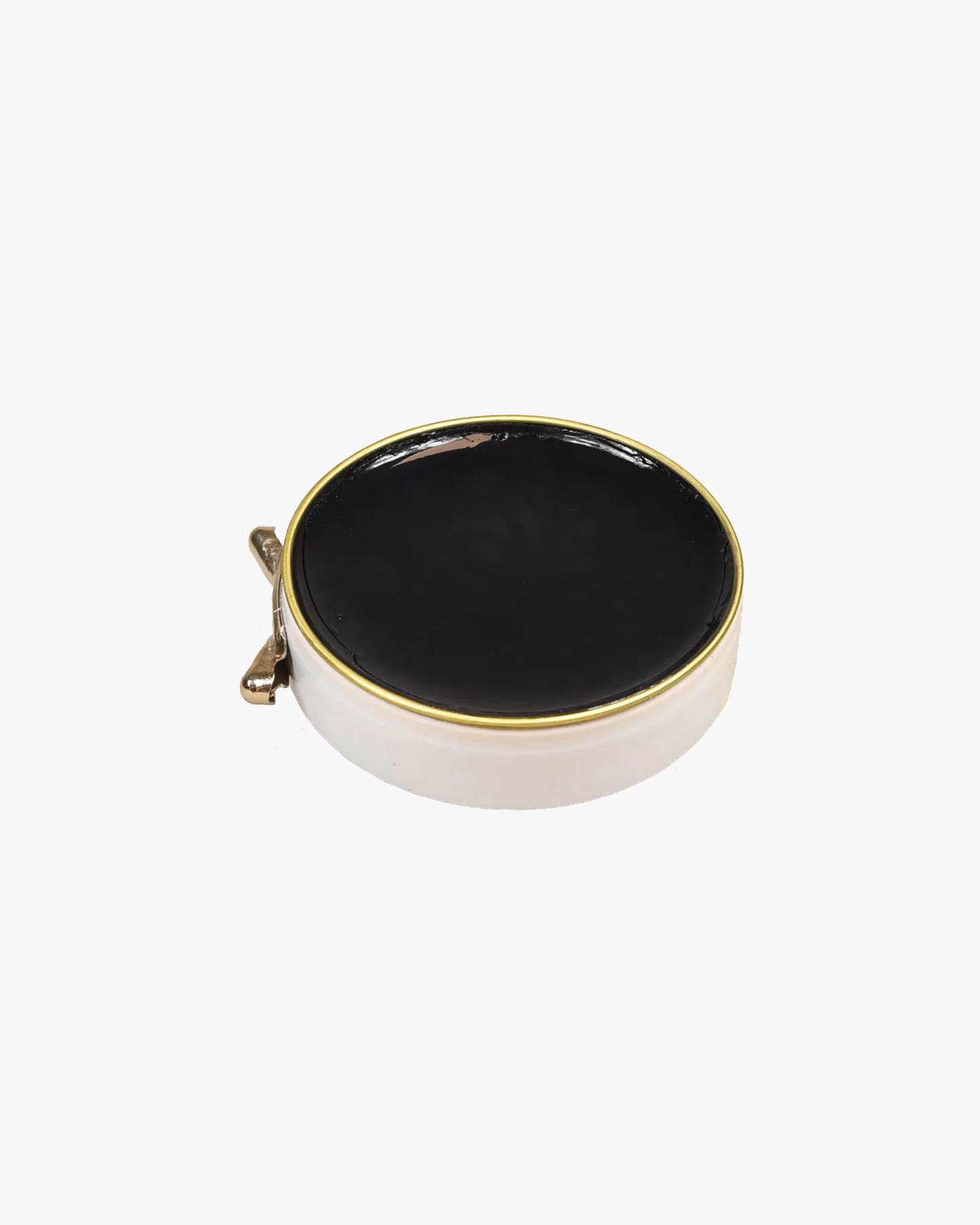 A close-up of an open tin of Saphir – Pâte de Luxe, showing the black shoe wax inside.
