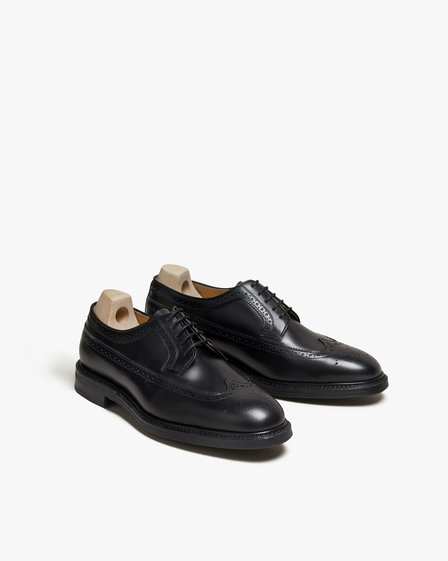 A three-quarter view of Orust – Black Calf, showcasing the black calf leather, long-wing broguing, and storm welt.