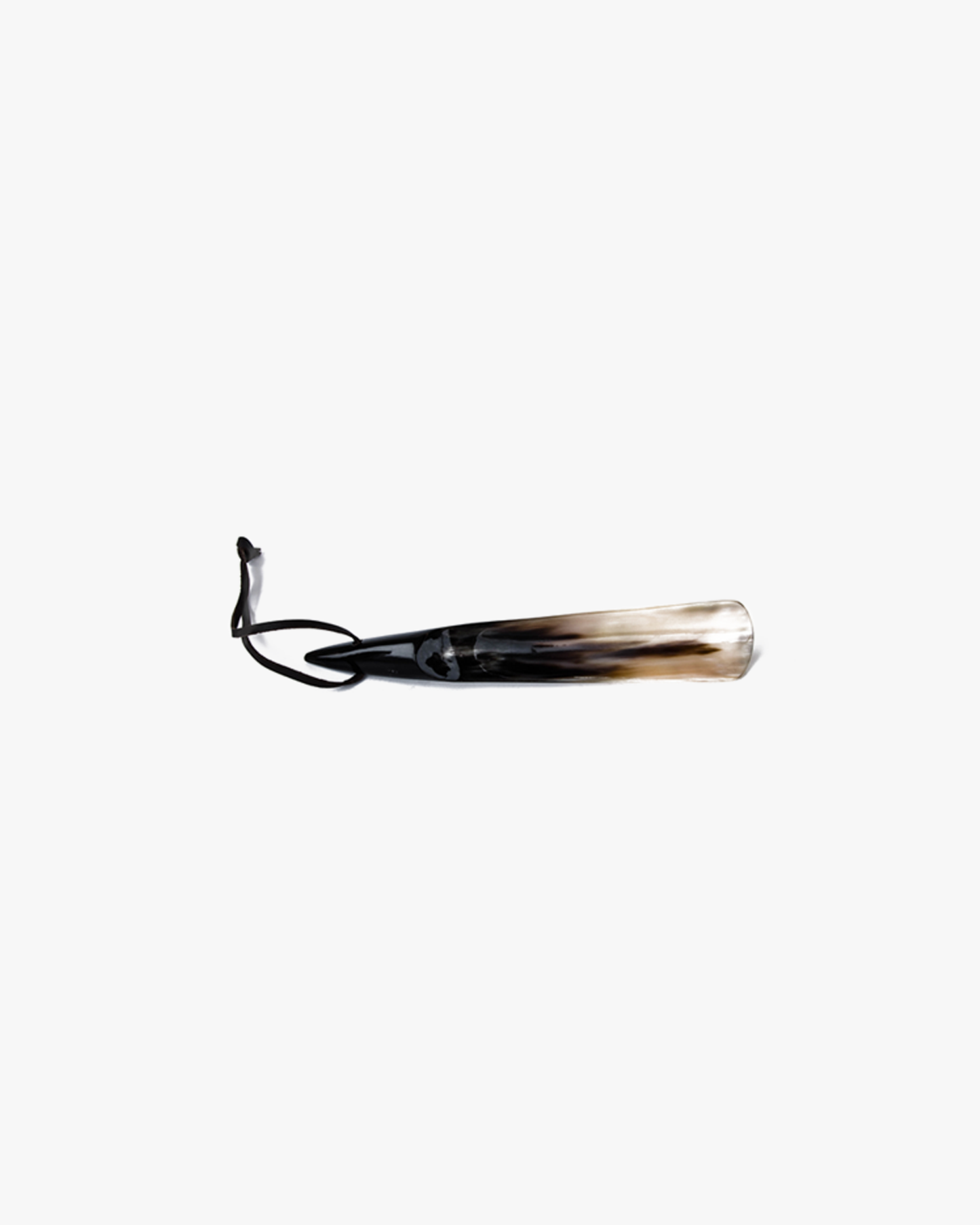 A shoe horn crafted from genuine cow horn, featuring a leather thong, on a white background.