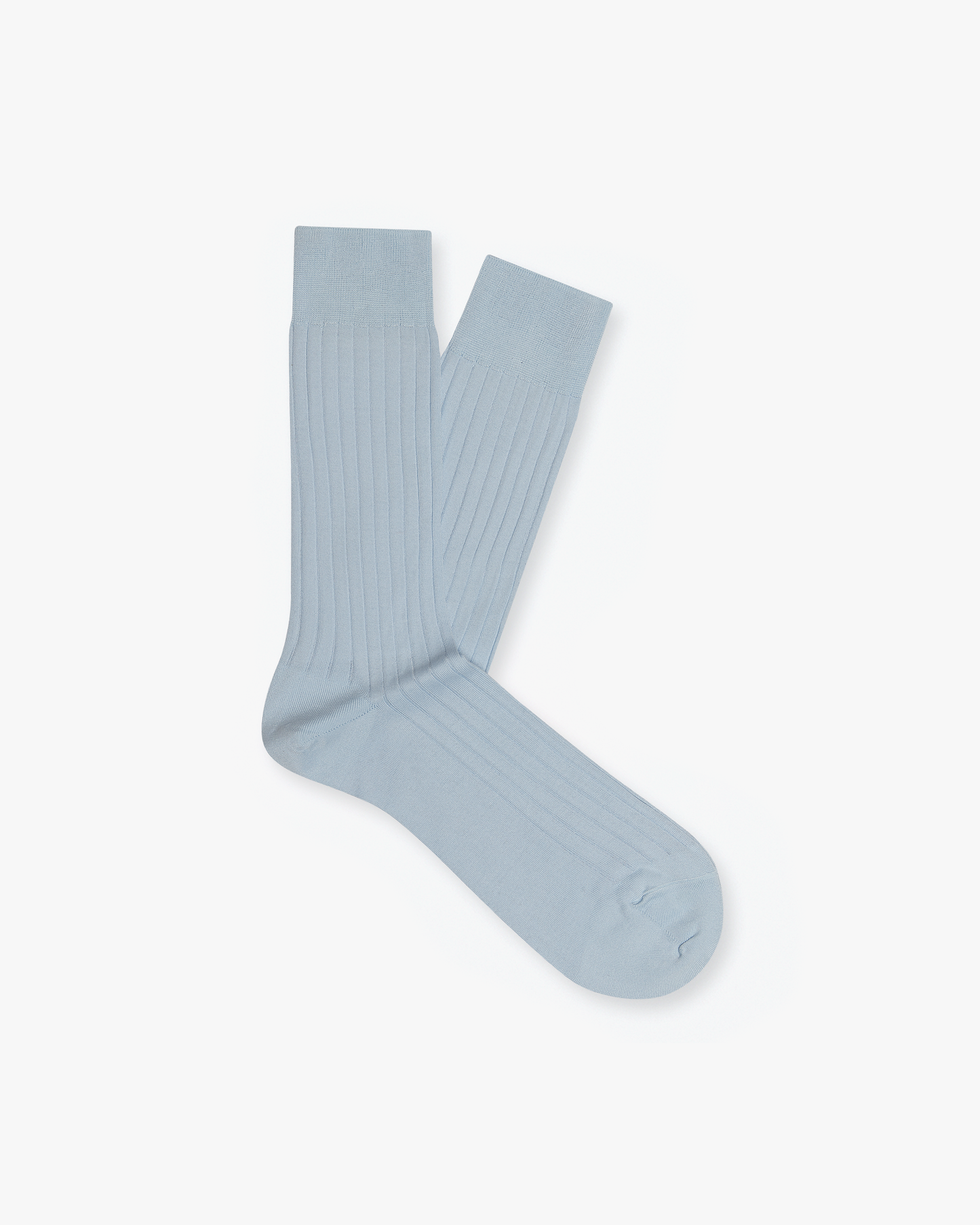 A pair of the ribbed Alvar – Cotton Socks in sky blue, displayed on a white background.