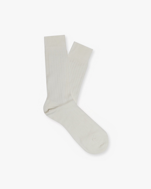 A pair of Alvar – Cotton Socks in pearl, laid flat to showcase their ribbed texture against a white background.