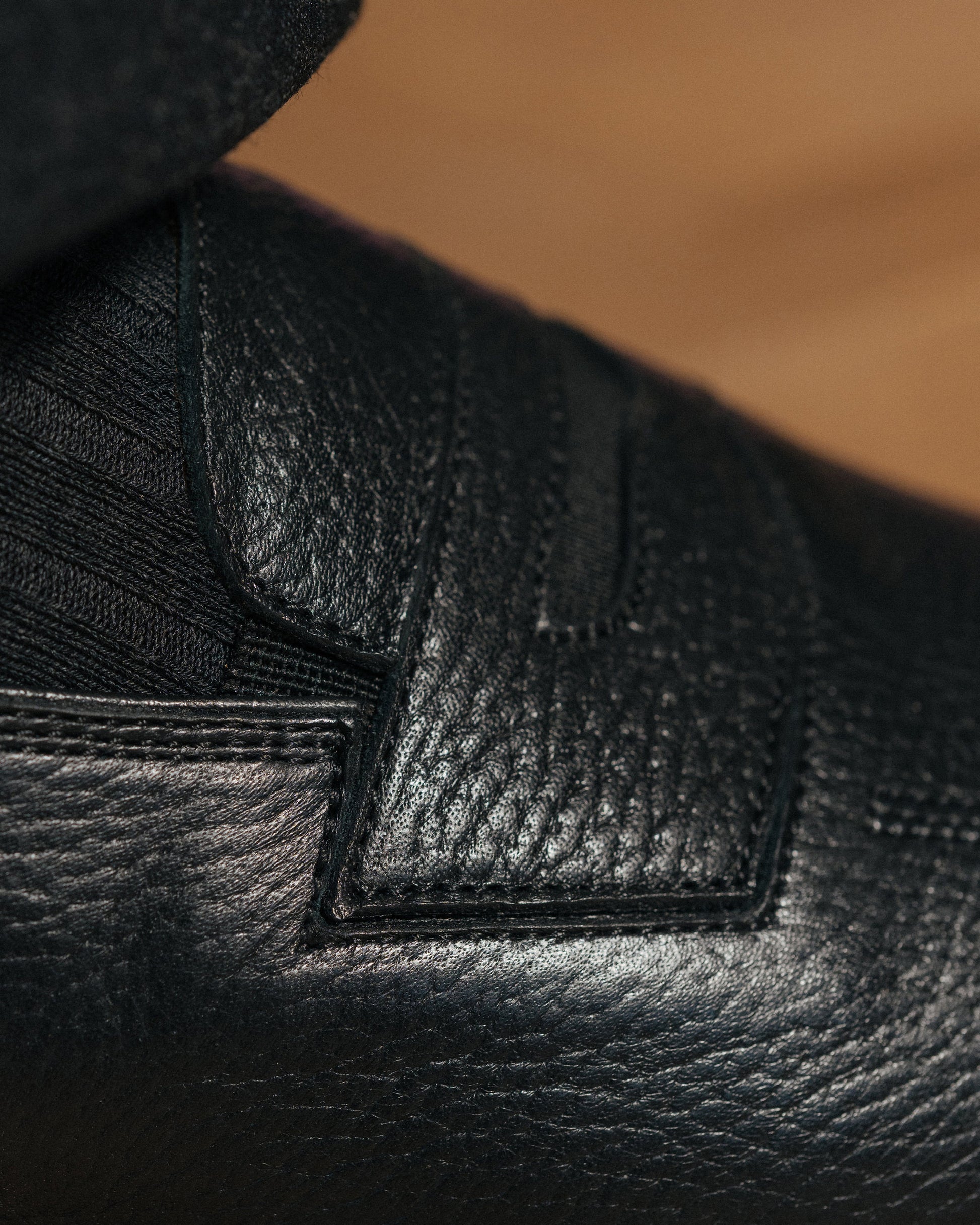 Detailed close-up of Sigtuna – Black Natural Grain highlighting textured leather and intricate stitching.
