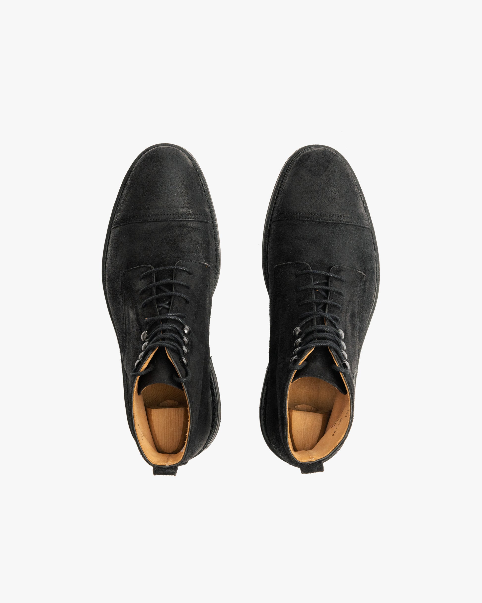 Top-down view of Abisko – Black Waxed Suede boots, showing the cap-toe design and texture on a white background.