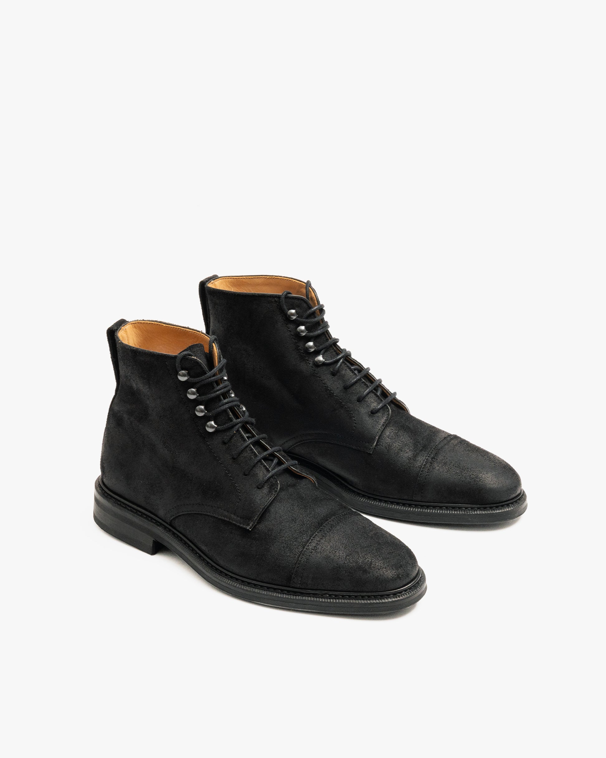 A pair of Abisko – Black Waxed Suede boots shown at a three-quarter angle against a white background.