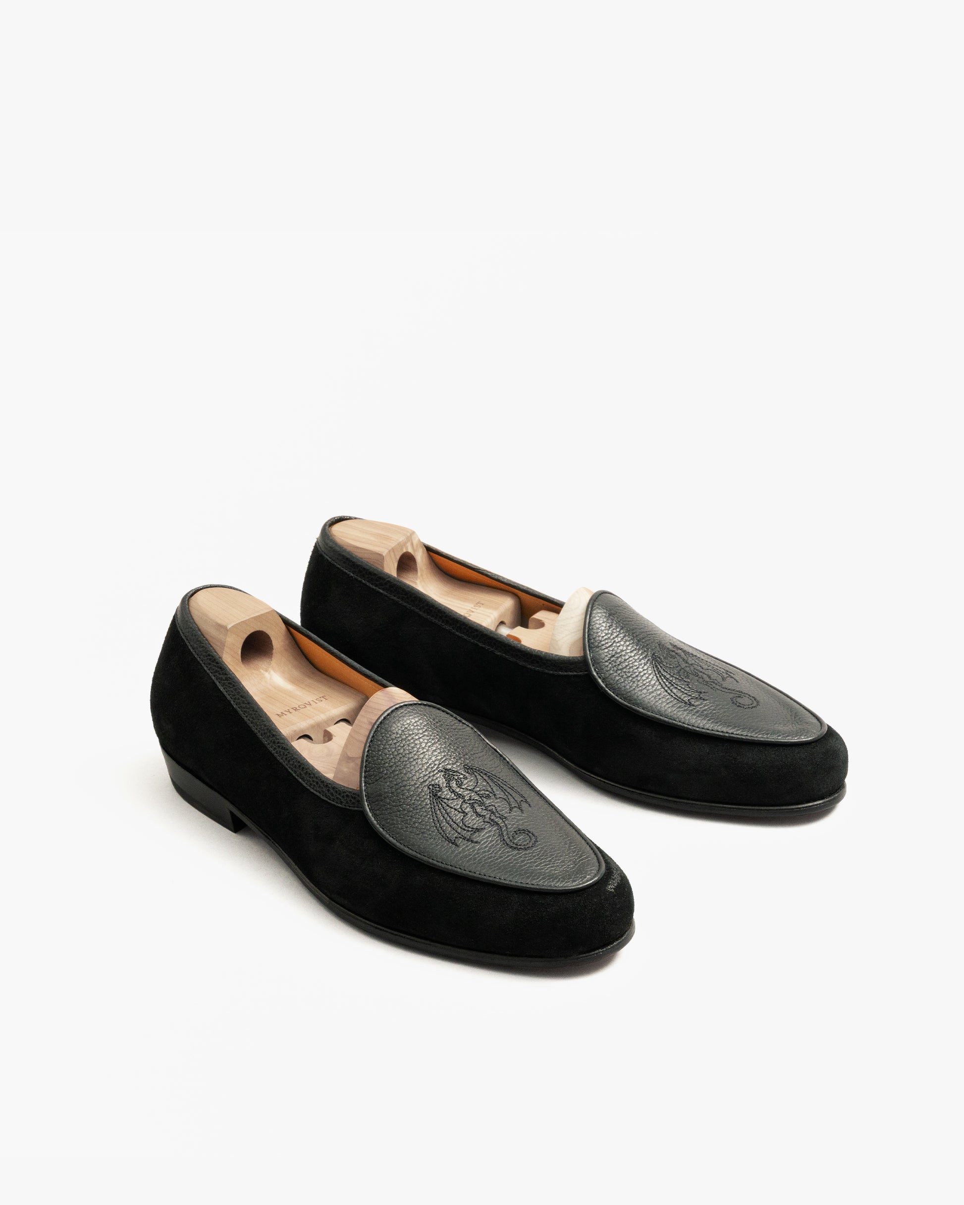 A pair of Ängby – Fares Edition loafers in black suede and leather, angled to highlight the intricate dragon embroidery.