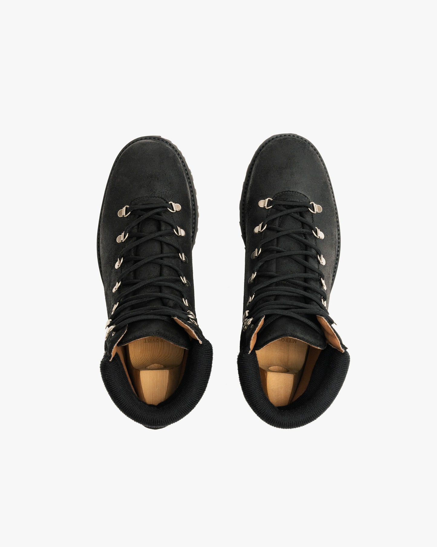 A top-down view of the Duved II – Black Waxed Suede boots with shoe trees inside, displayed on a white background.