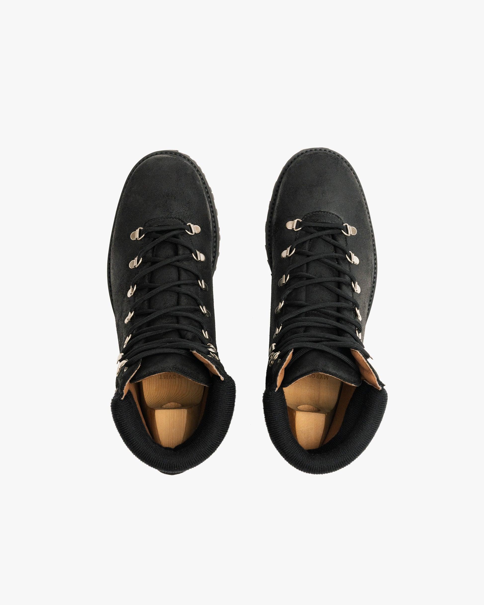 A top-down view of the Duved II – Black Waxed Suede boots with shoe trees inside, displayed on a white background.