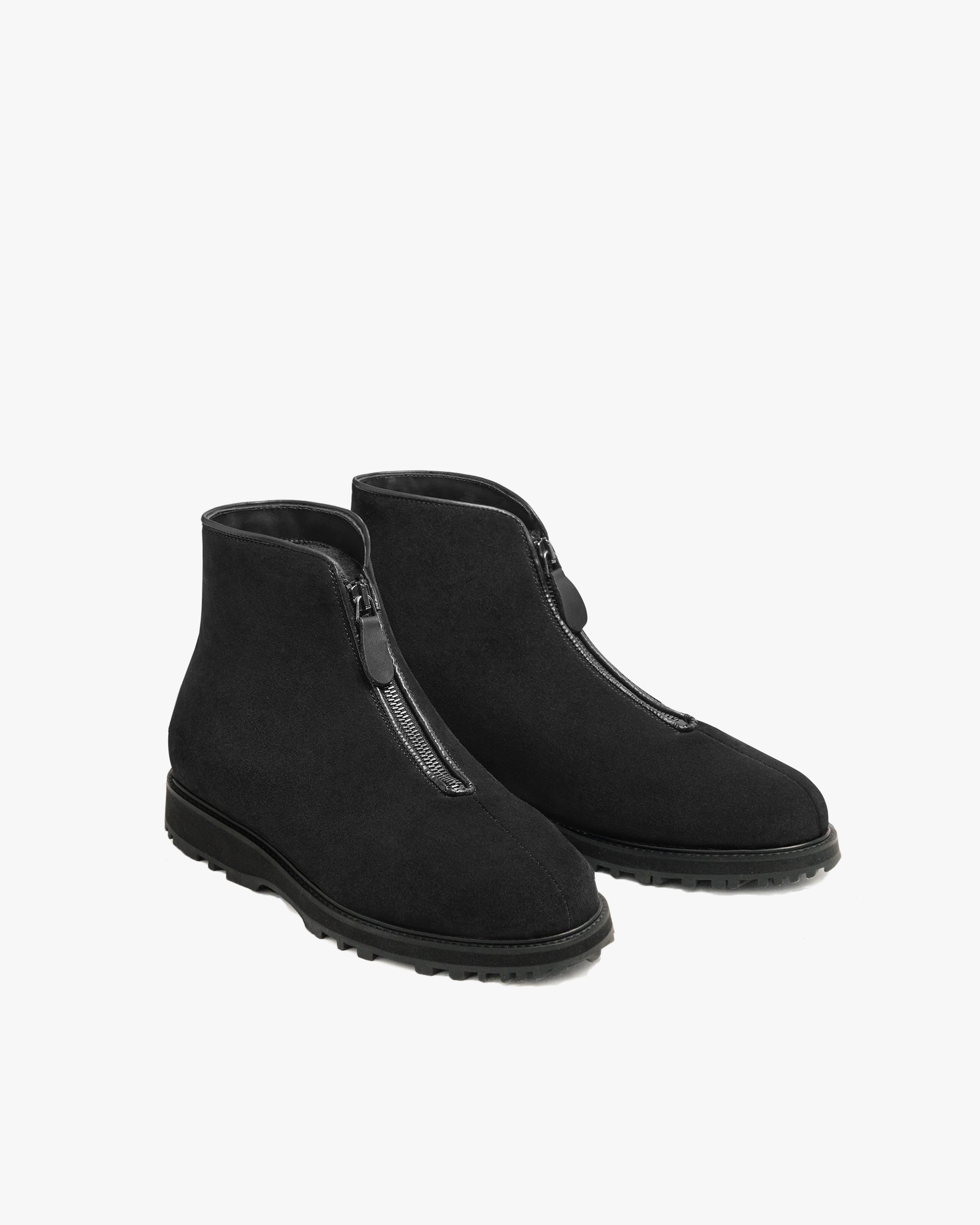 Funäs in black suede shown at an angle, featuring water-repellent suede uppers, central zip closures with leather pulls, and sturdy Explorer soles for versatile winter wear.