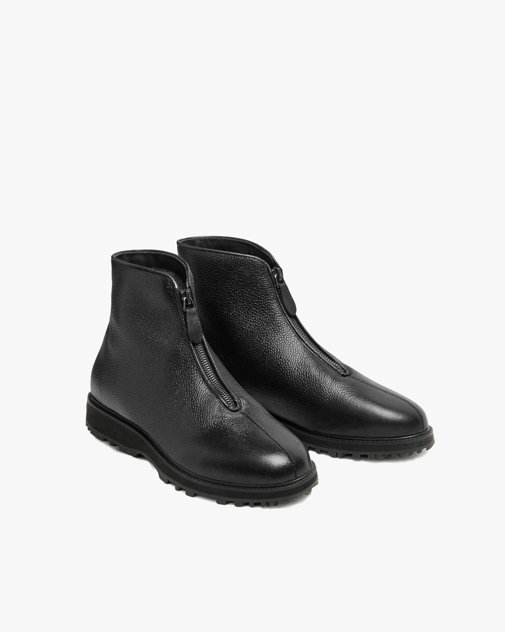 Funäs in black country calf, a pair of black ankle boots with central zippers, textured full-grain leather, and sturdy Explorer soles, designed for versatile winter wear.