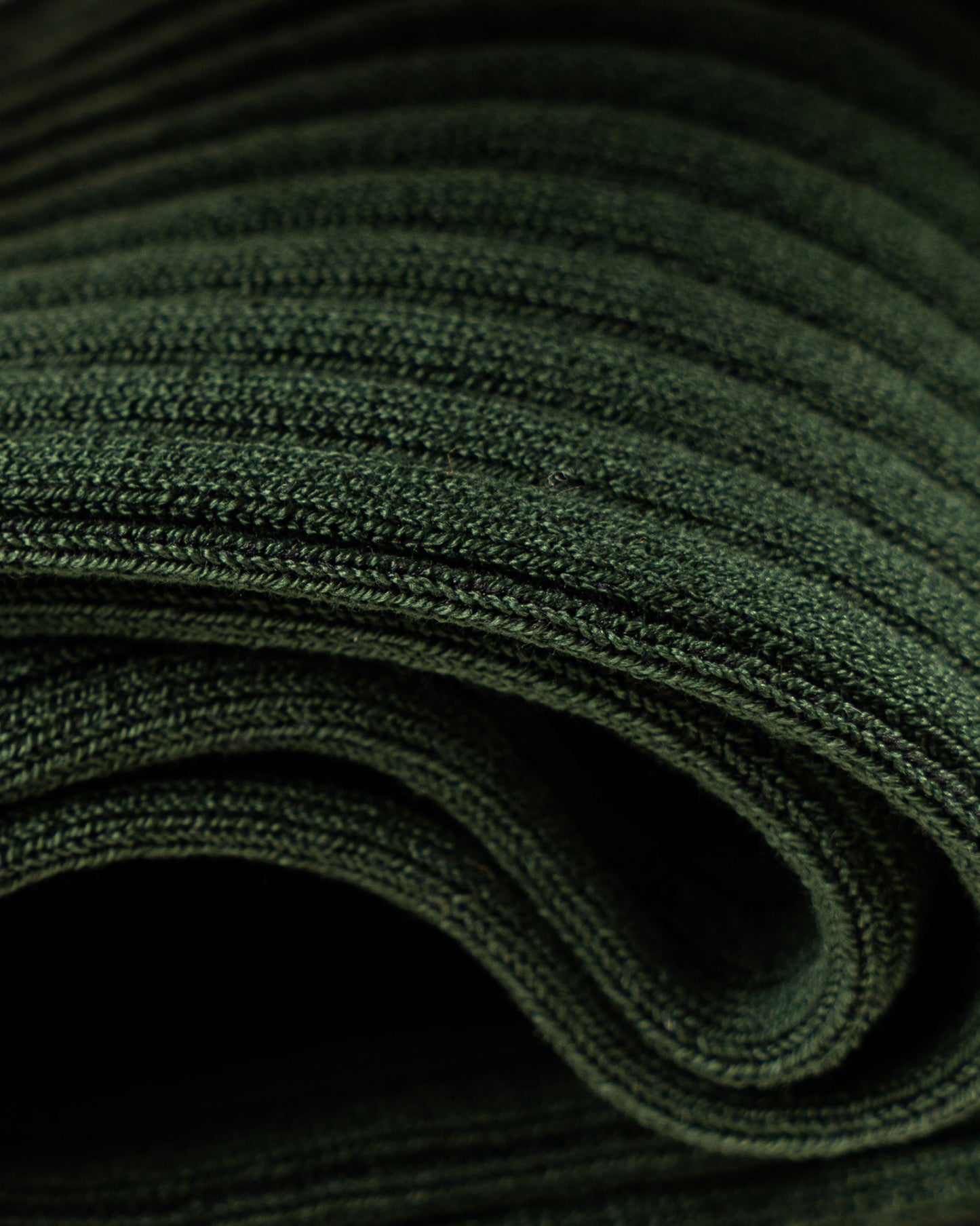 A detailed close-up of Nils – Knee-High Cotton Socks – Dark Green, highlighting the fine ribbed texture of the fabric.