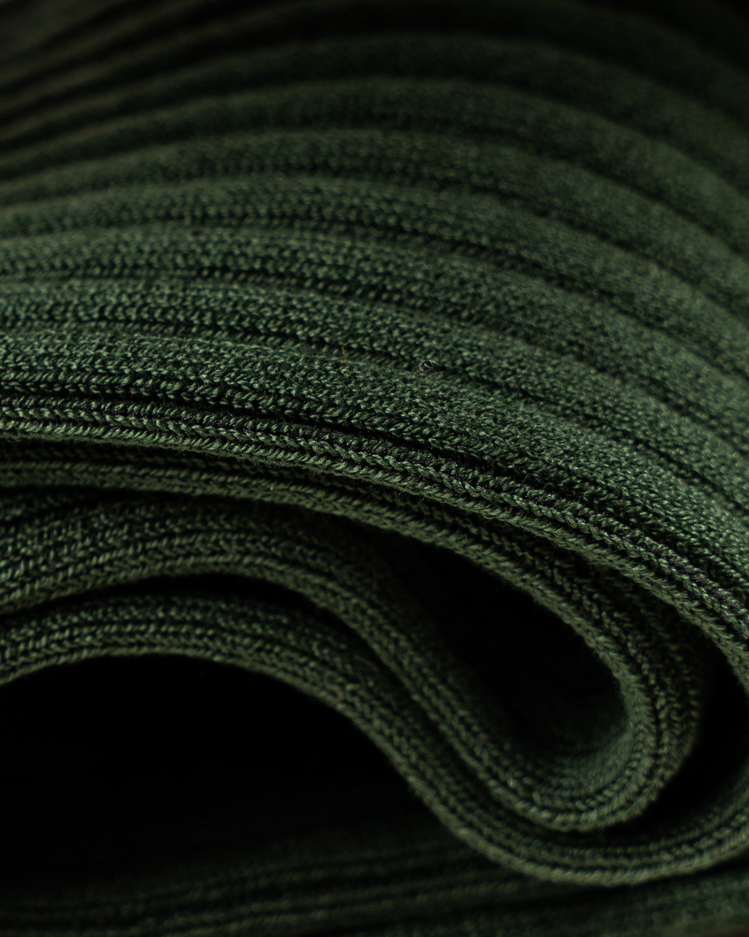 A detailed close-up of Nils – Knee-High Cotton Socks – Dark Green, highlighting the fine ribbed texture of the fabric.