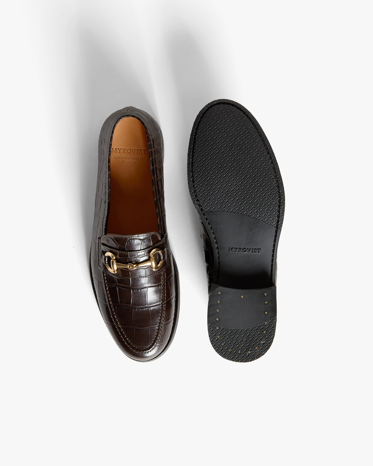 Karlberg – Dark Brown Croco shown with one loafer displaying a horsebit and the other showing the sole.