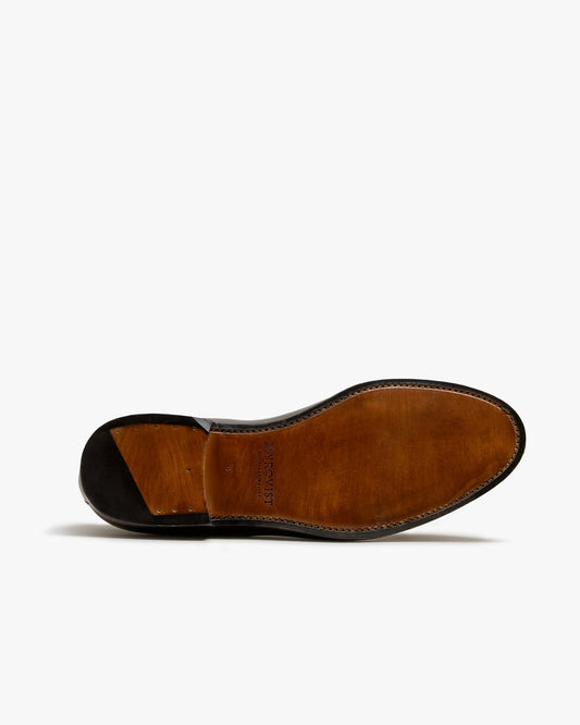 The sole of Lysekil II in dark brown suede, showcasing its smooth leather construction, Blake stitching, and the Myrqvist logo stamped at the midfoot.