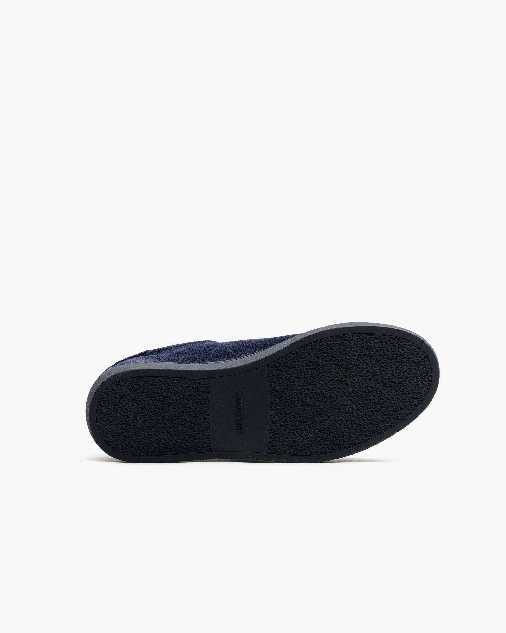 Oaxen Monochrome in navy suede shown with the sole facing up, highlighting the textured M-pattern sole and subtle Myrqvist branding for grip and durability.