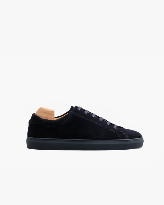 Oaxen Monochrome in navy suede shown in a side profile, featuring a seamless monochrome design with matching laces, stitching, and a color-matched sole, complemented by a wooden shoe tree inside.