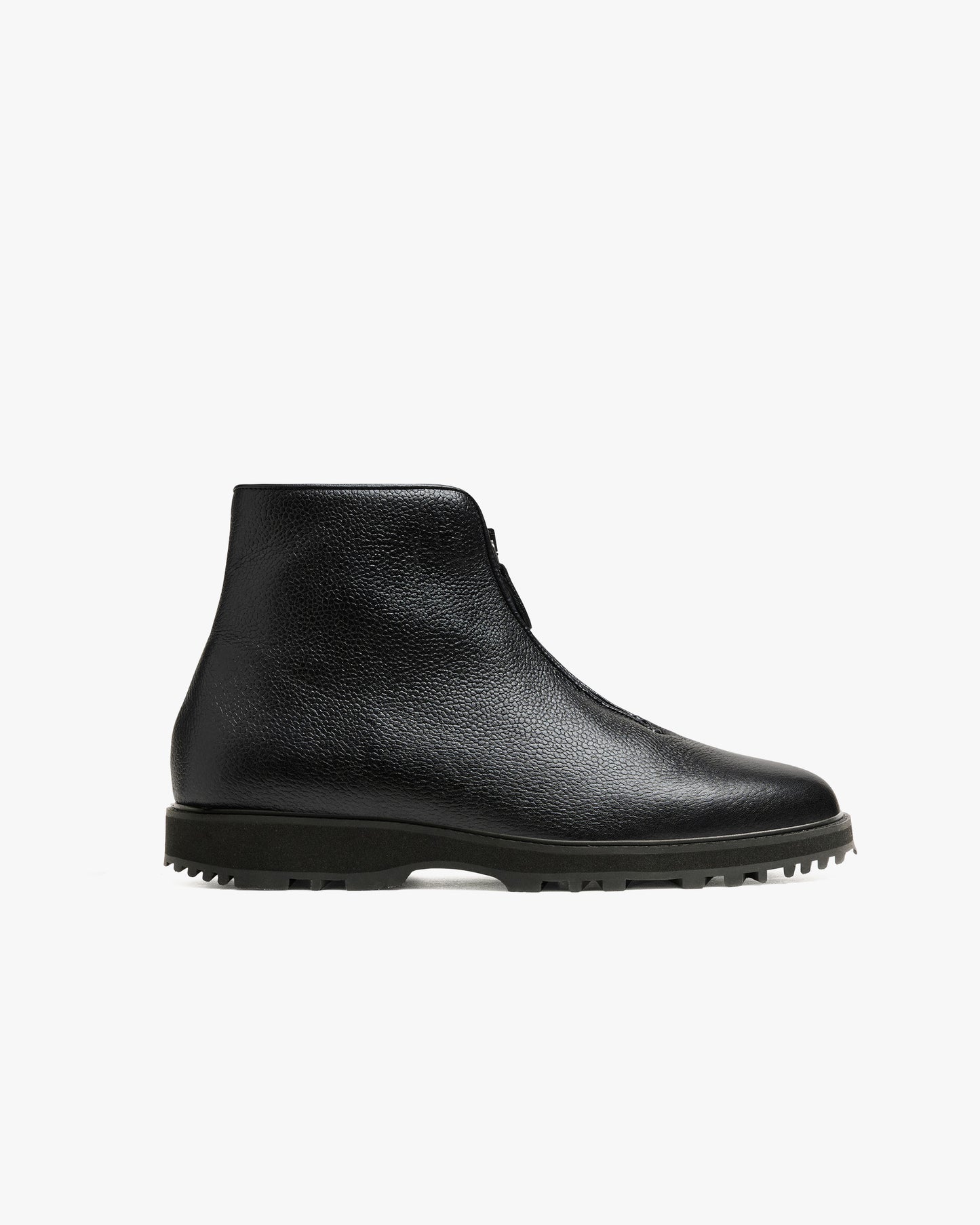 Funäs in black country calf, a minimalist black ankle boot with a central zipper, textured full-grain leather, and a rugged Explorer sole designed for versatile winter wear.