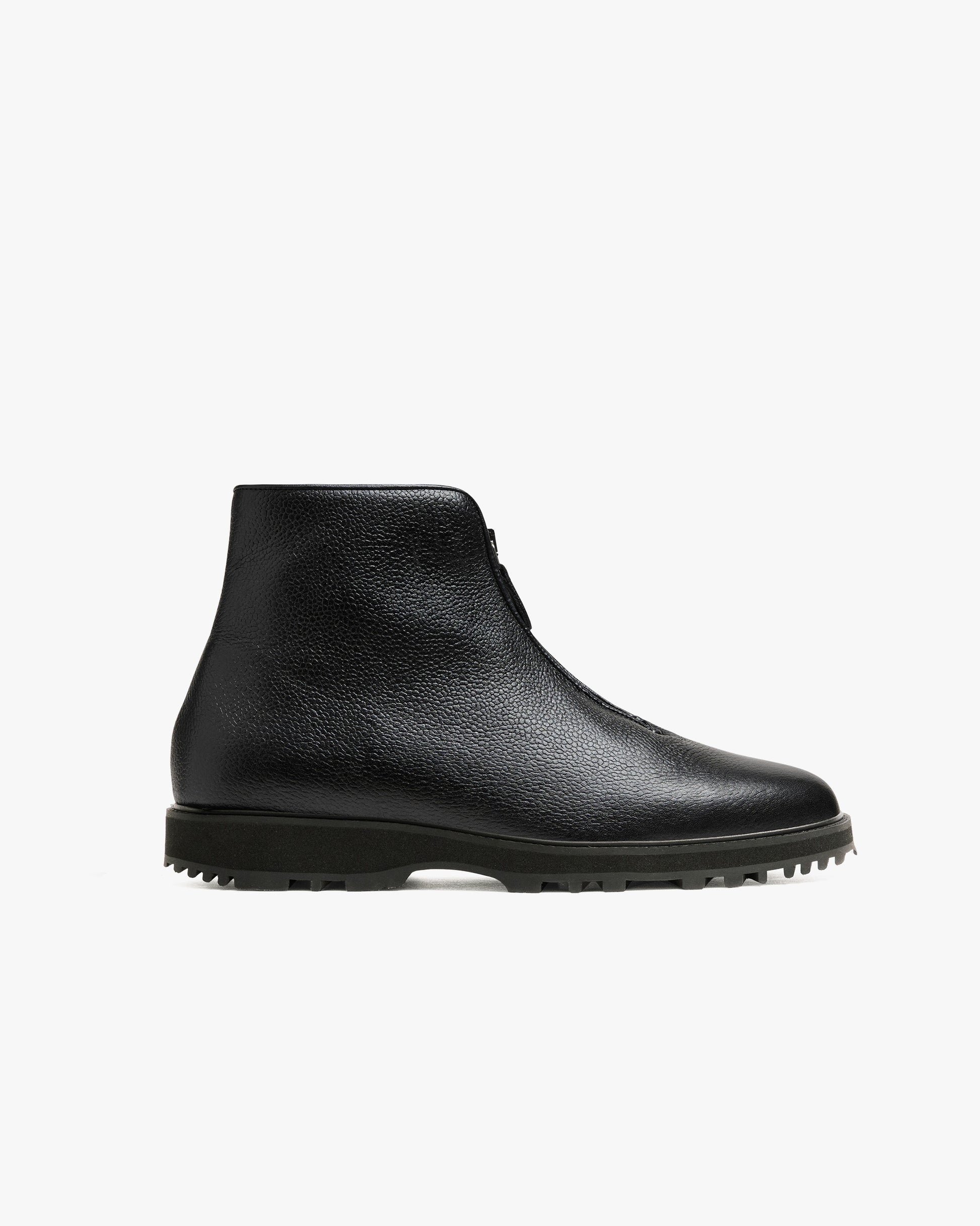 Funäs in black country calf, a minimalist black ankle boot with a central zipper, textured full-grain leather, and a rugged Explorer sole designed for versatile winter wear.
