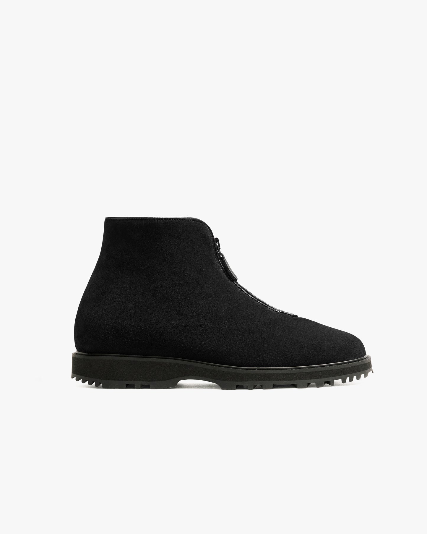 Minimalist black suede boot with a central zipper, rugged Explorer sole, and clean silhouette, designed for versatile wear in both formal and casual winter settings.