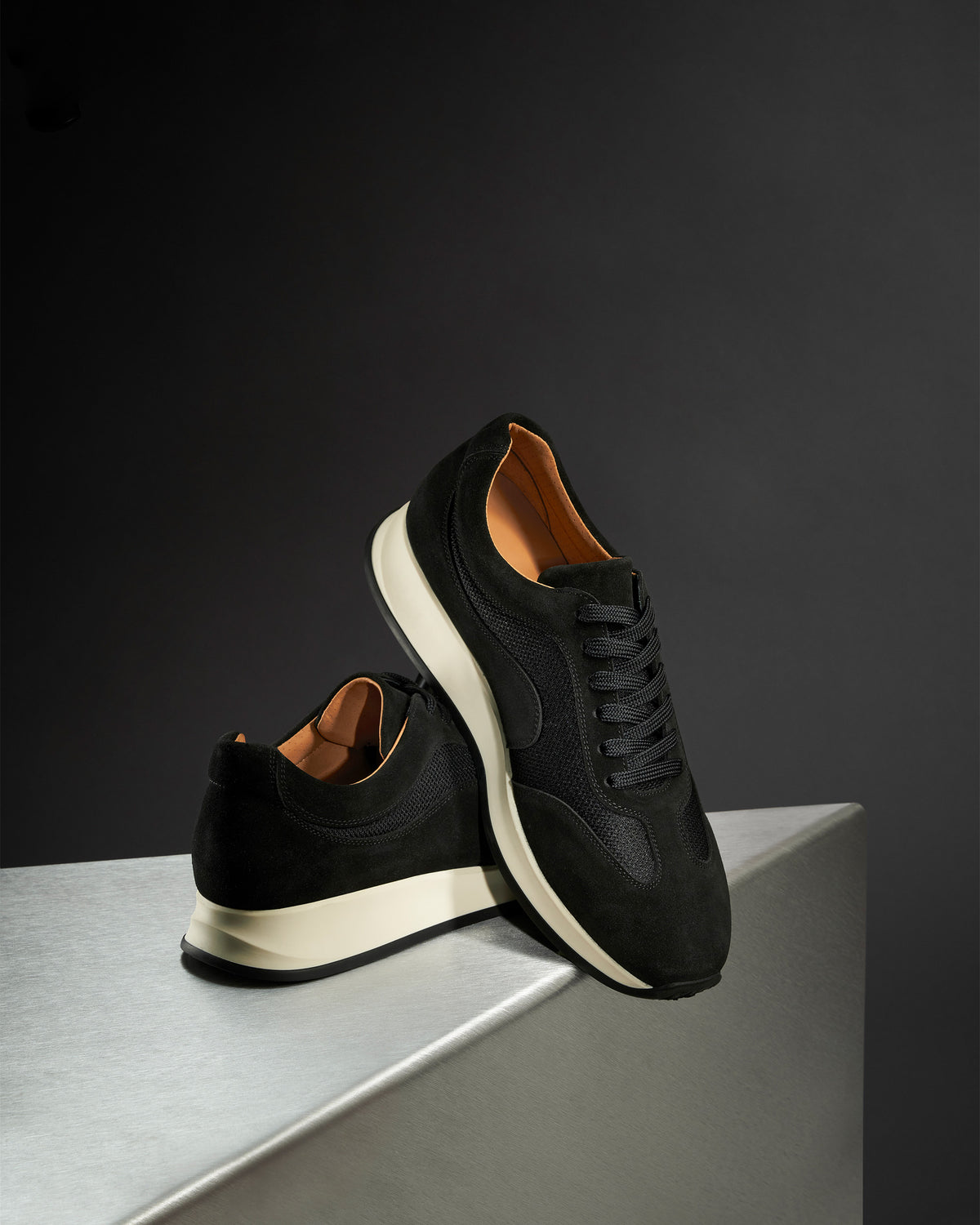 Stensund II – Black Suede sneakers in soft black suede and mesh on a metallic surface.