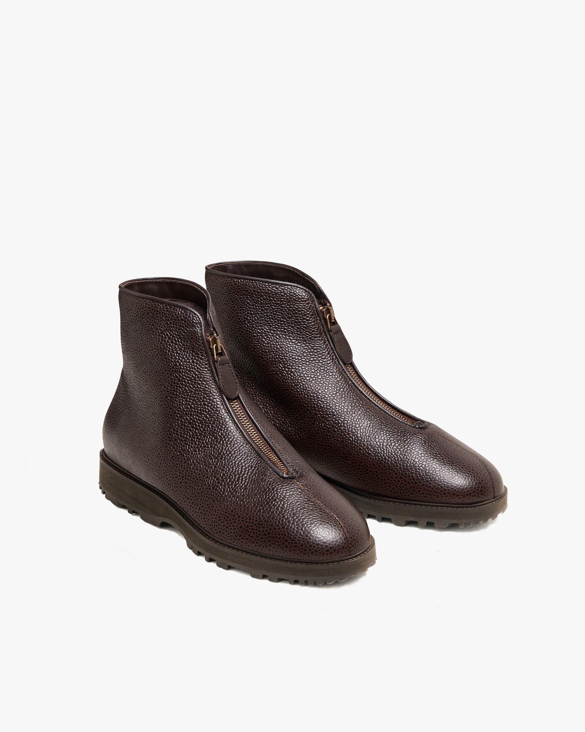 A pair of Funäs – Dark Brown Country Calf boots with front zippers and rugged soles, shot against a plain white background.