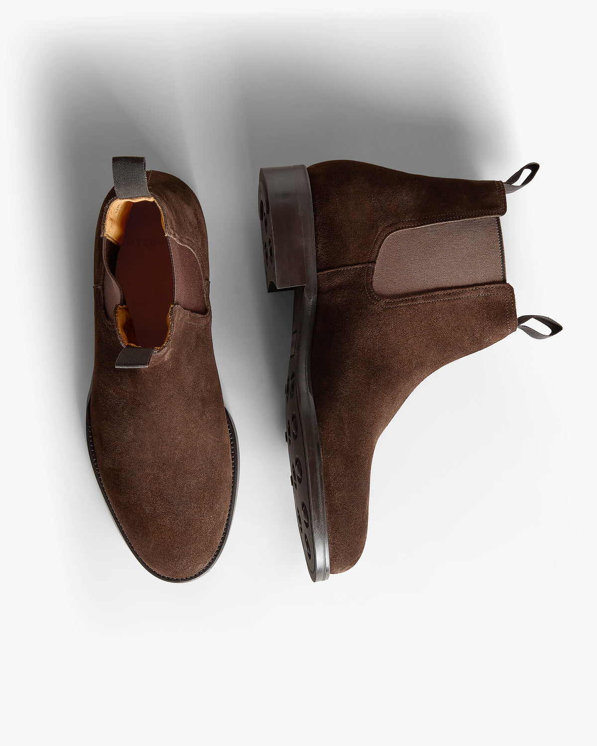Elfvik II – Dark Brown Suede shown with one shoe viewed from above and one showing the sole.