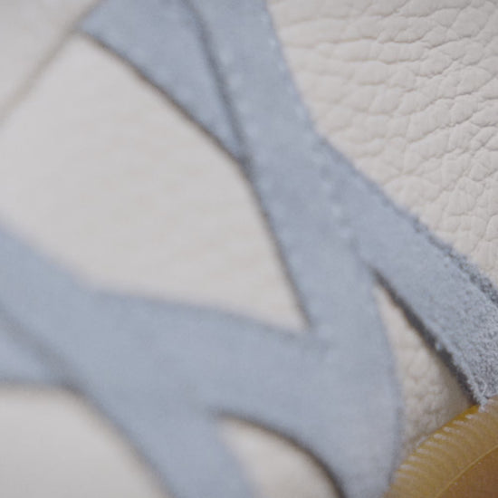 Högalid – White Natural Grain sneaker in white tumbled leather with suede accents and the abstract M side motif.